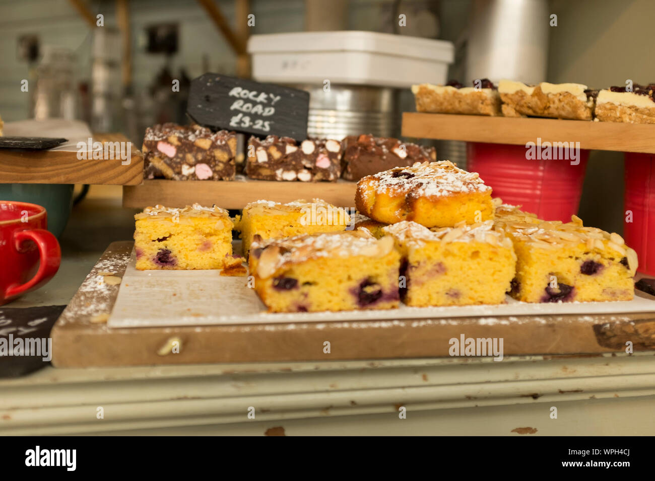 Display of various types of cakes in a cafe, Gloucestershire, UK Stock Photo