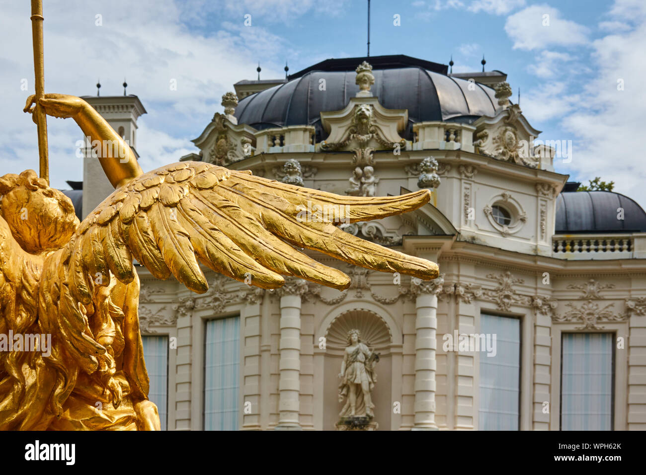 Ettal, Germany, August 6., 2019: Wings of the statue of a gold-plated angel in front of the castle, Linderhof, the pleasure palace of King Ludwig II o Stock Photo