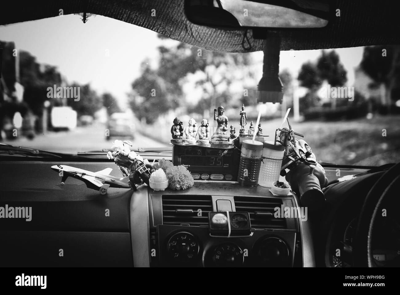 Figurines On Car Dashboard Stock Photo Alamy