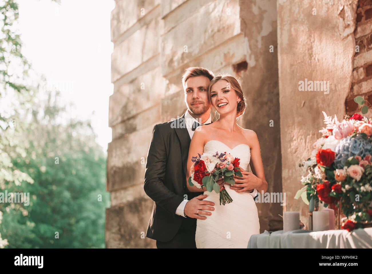portrait of happy bride and groom standing together Stock Photo - Alamy