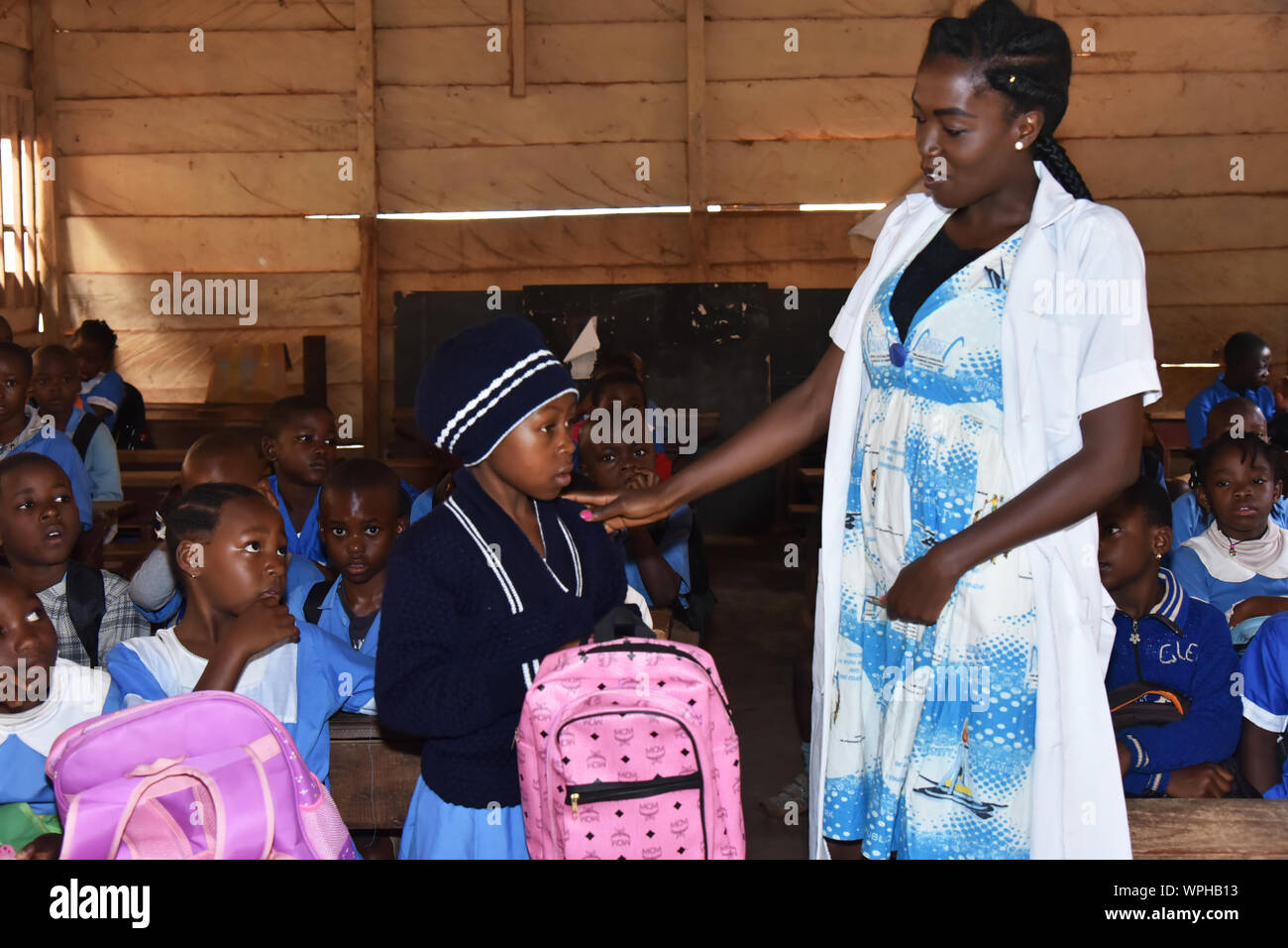 Foumban, Cameroon. 2nd Sep, 2019. A teacher welcomes Kelsy Shinyuy on the day of school reopening in Foumban, Cameroon, Sept. 2, 2019. TO GO WITH 'Feature: Cameroon's internally displaced children struggle to continue schooling amid separatist crisis' Credit: Jean Pierre Kepseu/Xinhua Stock Photo