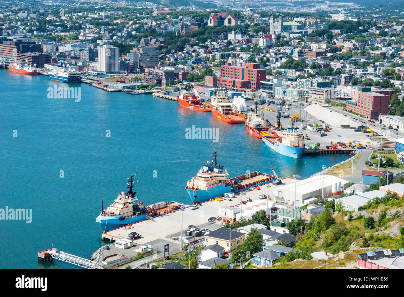 ST. JOHN'S, CANADA - AUGUST 26, 2015: Several offshore supply ships are docked in St. John's Harbour in Newfoundland. Stock Photo