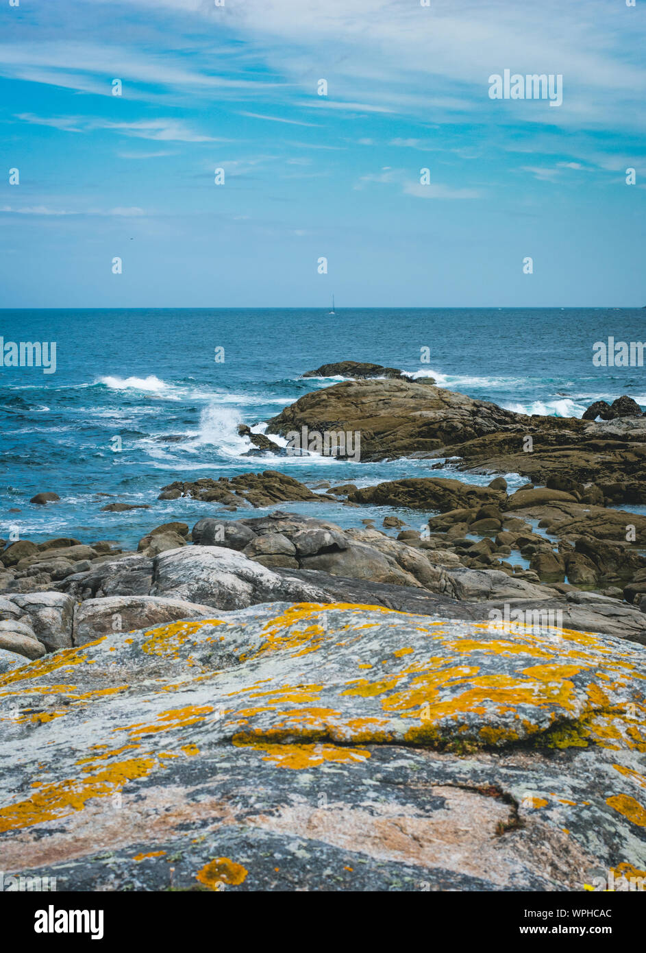 Ocean shore washing old massive stones in Muxia, Spain. Stock Photo