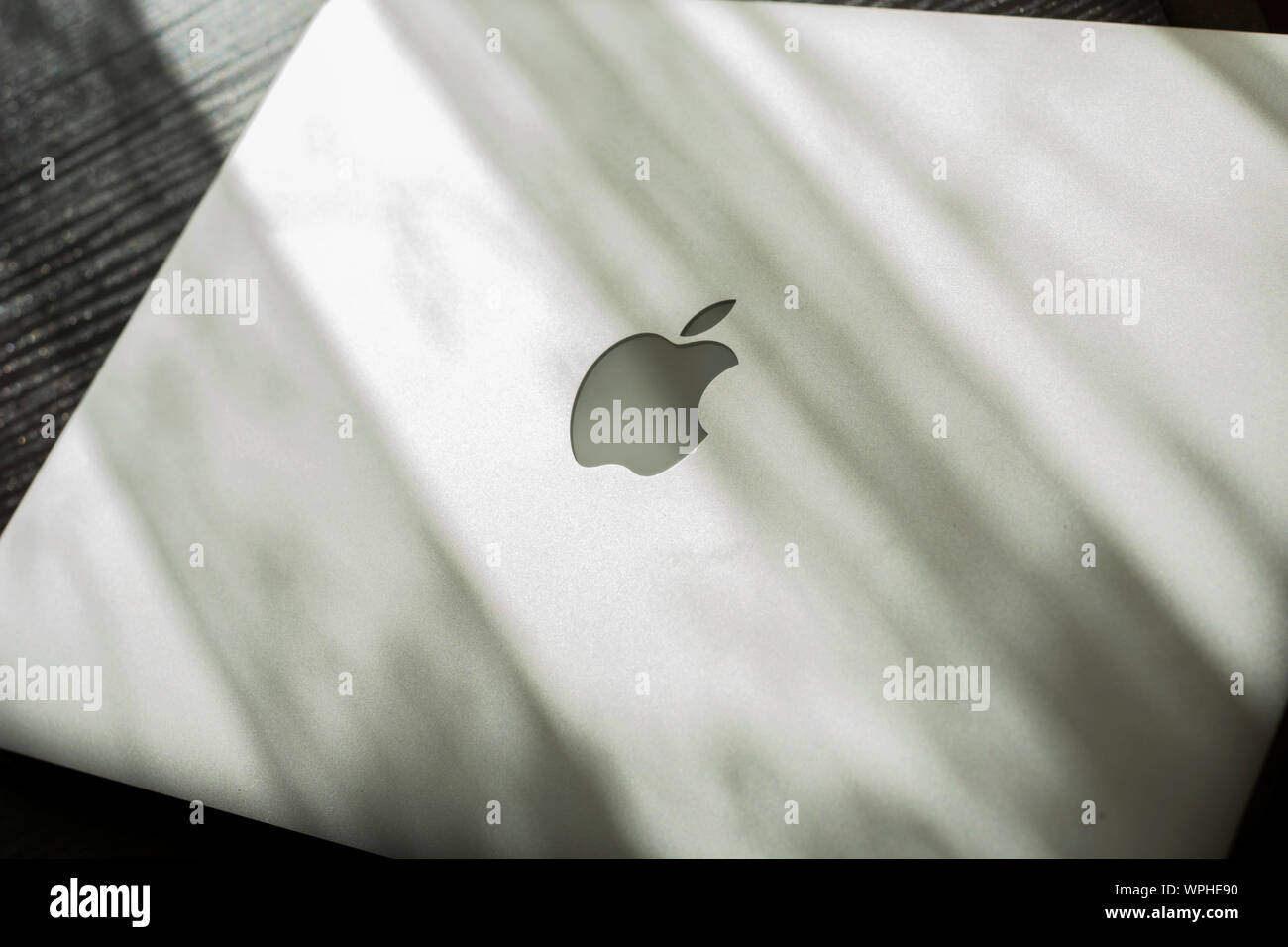 MacBook Air on sunny table. Stock Photo