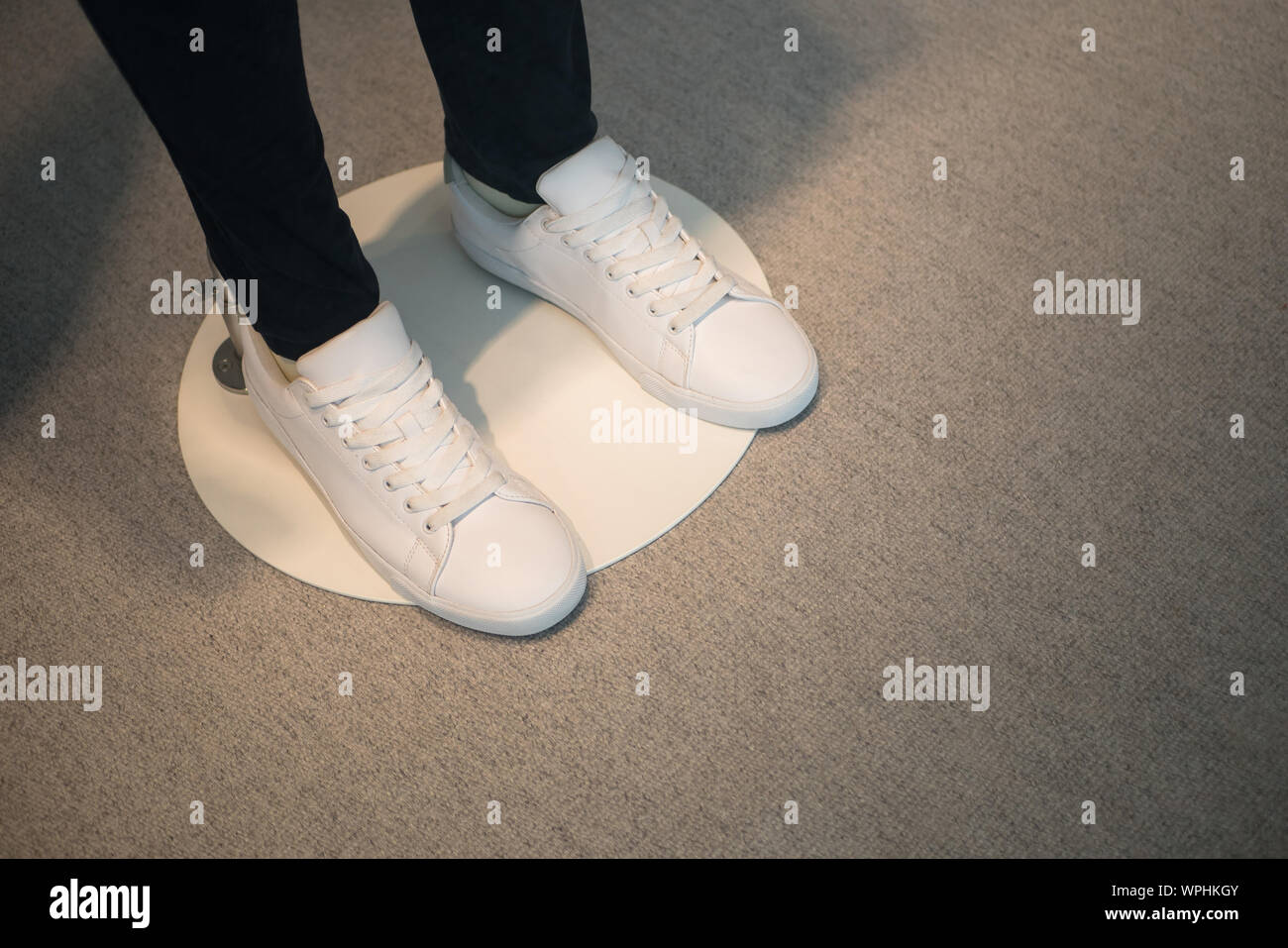 Window display of a male mannequin wearing white shoes Stock Photo Alamy