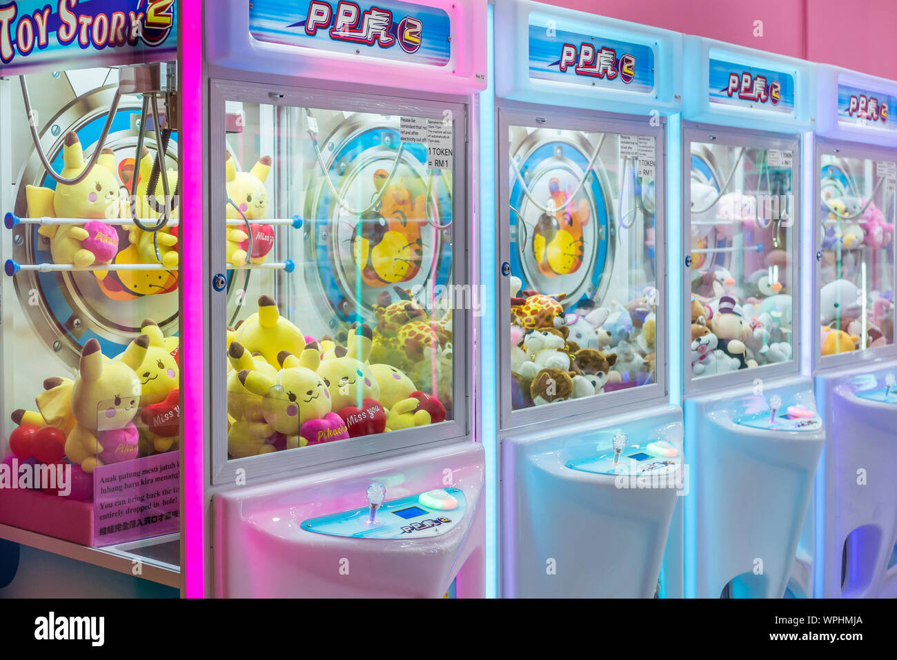Kuala Lumpur,Malaysia - September 7,2019 : Colorful arcade game toy claw crane machine where people can win toys and other prizes. Stock Photo