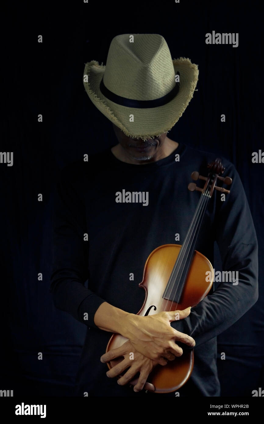 Man playing violin on dark tone Stock Photo