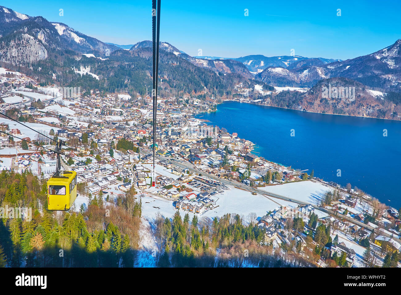 The cable car journey to Zwolferhorn mountain top over the tourist village of St Gilgen and scenic Wolfgangsee lake, Salzkammergut, Austria Stock Photo