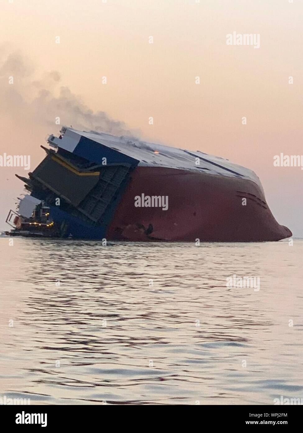 St Simons Island, Georgia, USA. 08 September, 2019. The M/V Golden Ray cargo ship rests inverted in the water after suffering a fire and capsizing in St Simons Sound Aerial September 8, 2019 off St Simons, Georgia, USA. The 656-foot-long vehicle carrier, listing heavily after suffering a fire with 24 crew members aboard.  Credit: U.S Coast Guard/Alamy Live News Stock Photo
