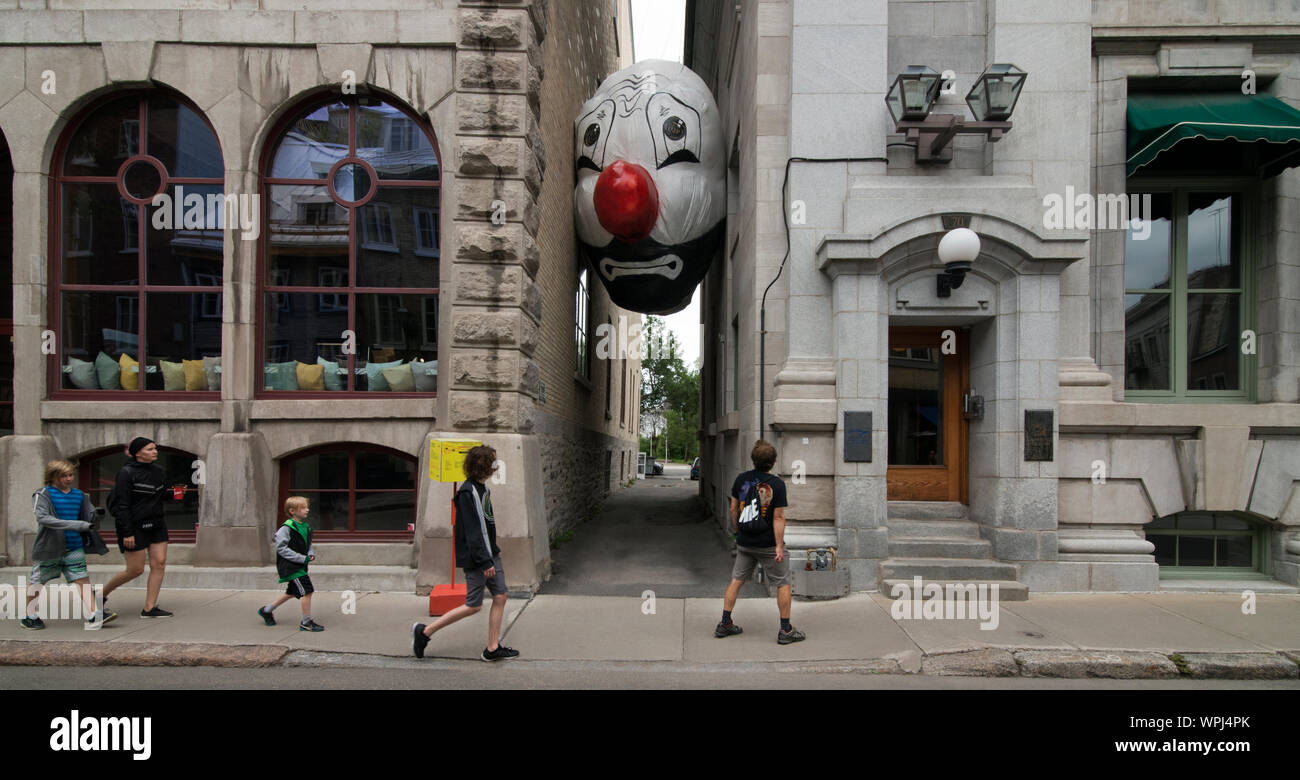 Endgame (Nagg & Nell) Inflatable clown head  on rue Saint-Paul Quebec, CA, by inflatable artist Max Streicher. Stock Photo