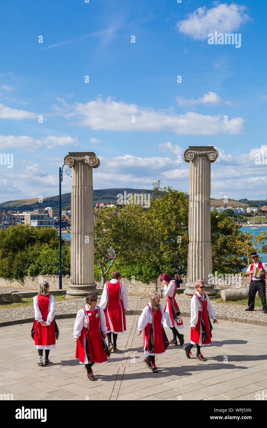 Female Morris dancers Hips and Haws Clog, perform at Swanage Folk Festival, Swanage, Dorset UK on a warm sunny day in September Stock Photo