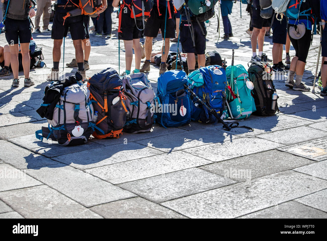 Group of Pilgrim backpack in a row on paving stone of Obradoiro square, Santiago de Compostela, Spain. Copy space Stock Photo