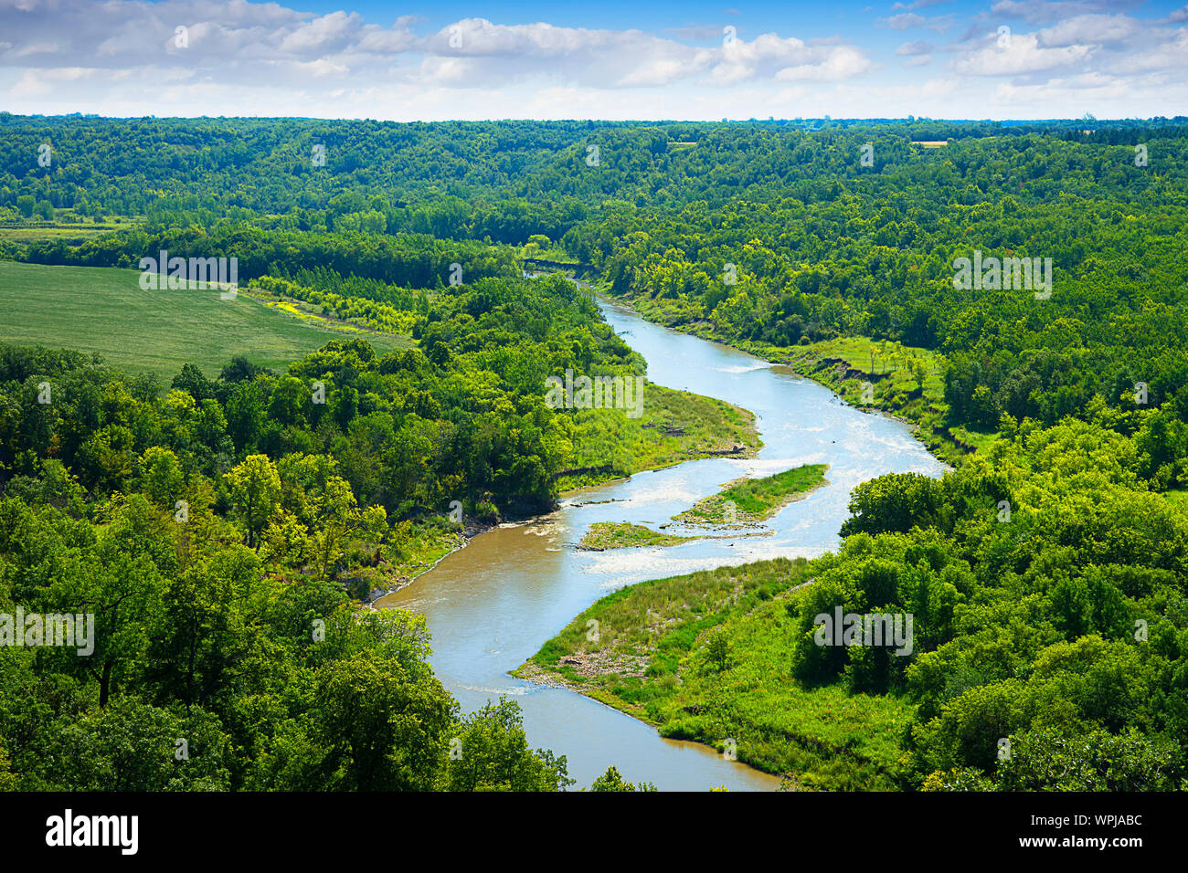 Beautiful river winding in an S-curve through lush forest covered landscape.  Location: Pembina Gorge just west of Walhalla, North Dakota, USA Stock Photo