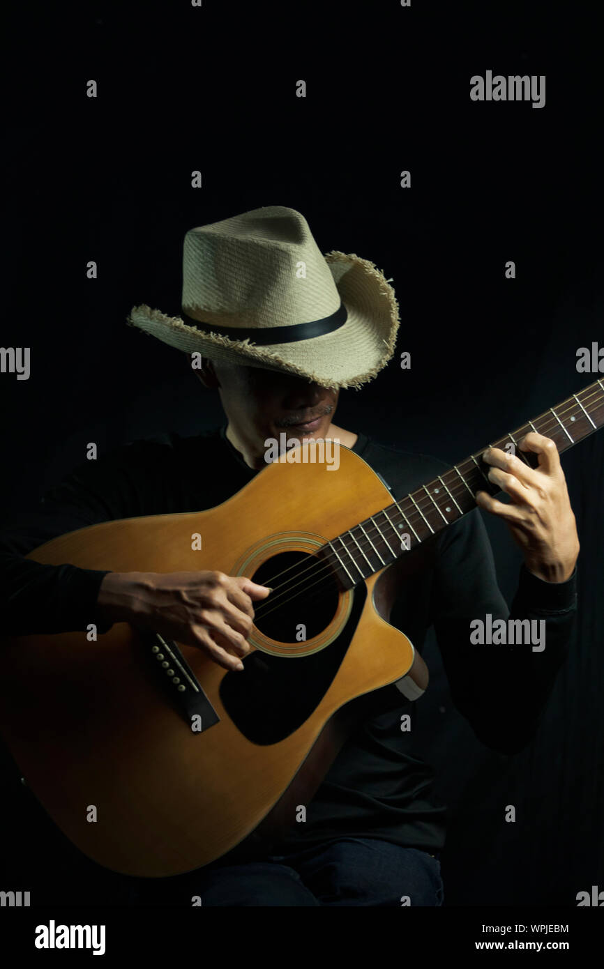 Close up man playing guitar Stock Photo - Alamy