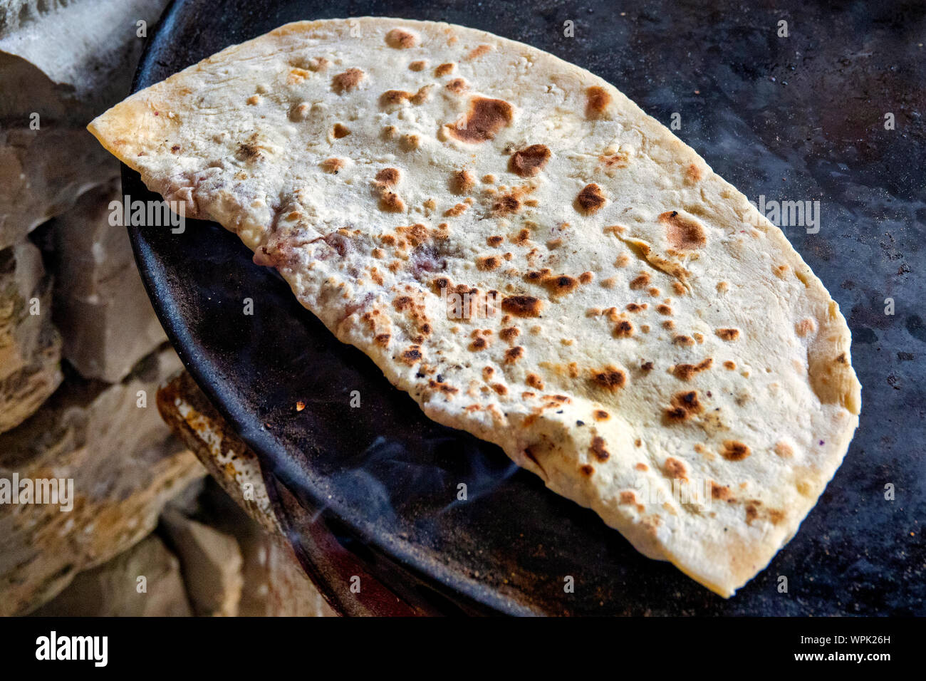 Qutab, an Azerbaijani dish made from thinly rolled dough ,cooked briefly on a convex griddle known as saj. Stock Photo