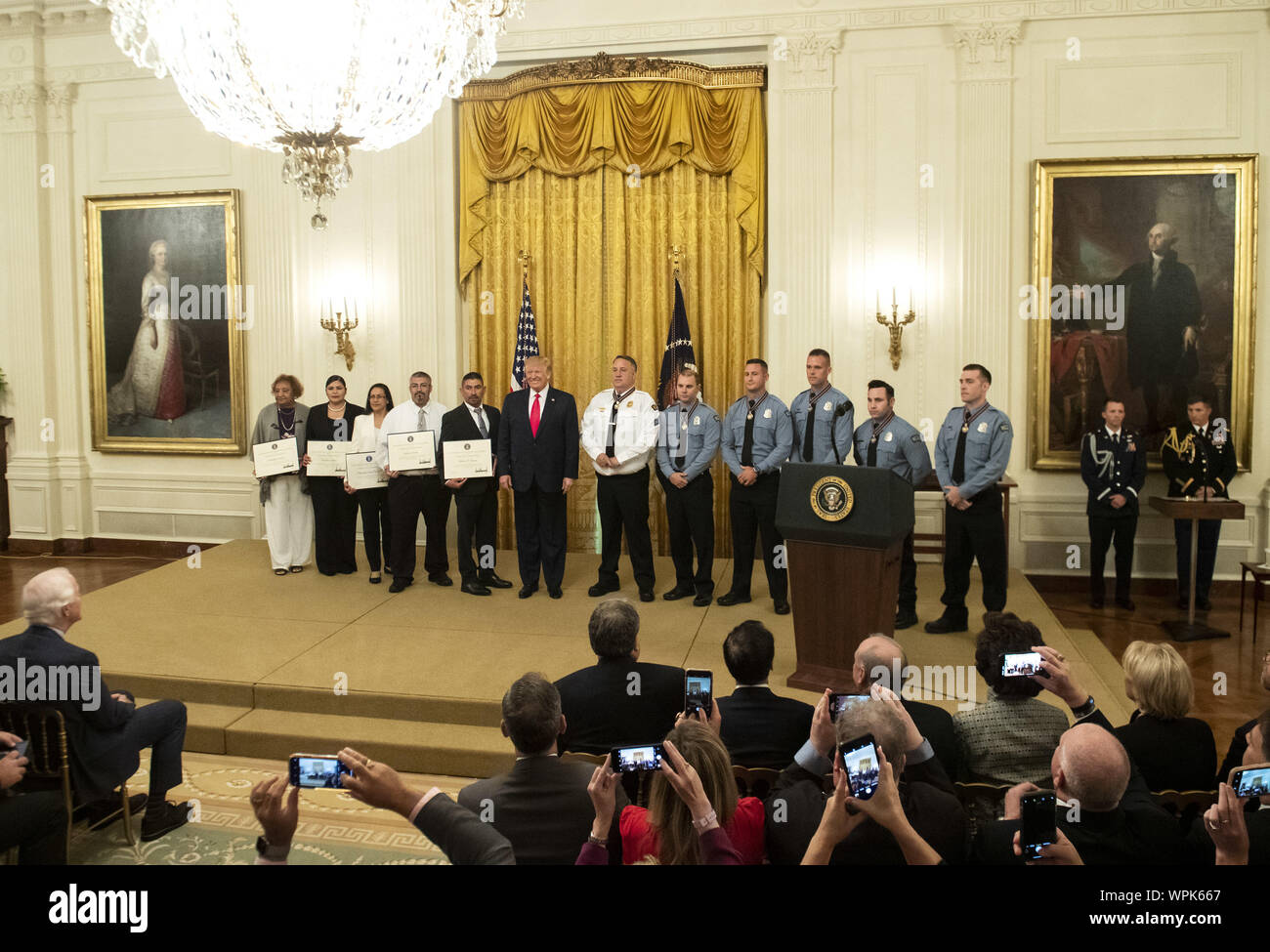 Washington, United States. 09th Sep, 2019. President Donald Trump stands with the recipients of the Public Safety Officer Medal of Valor and recipients of Heroic Commendations, during a ceremony in the East Room at the White House in Washington, DC on Monday, September 9, 2019. Trump recognized the six Dayton police officers who stoped a mass shooting on August 4th and honored 5 civilians who helped during a mass shooting at a Walmart in El Paso the day before. Photo by Kevin Dietsch/UPI Credit: UPI/Alamy Live News Stock Photo