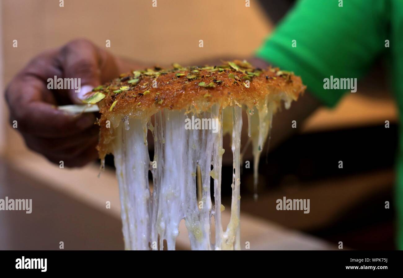 Amman, Jordan. 8th Sep, 2019. A vendor sells kunafa at a store in Amman, Jordan, Sept. 8, 2019