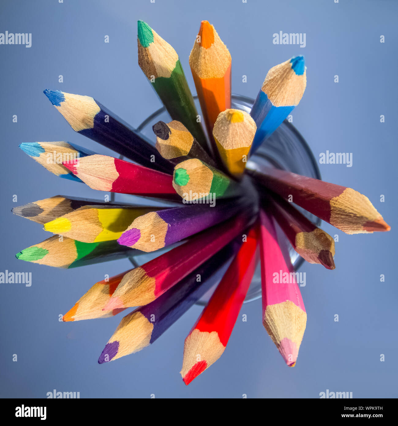 A group of coloured pencils in a glass tumbler Stock Photo