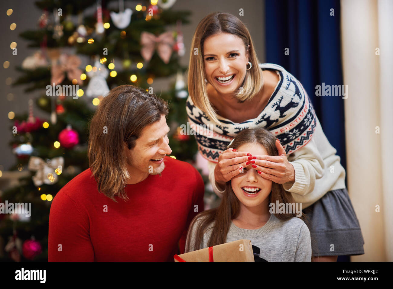 Beautiful family with presents under Christmas tree Stock Photo - Alamy