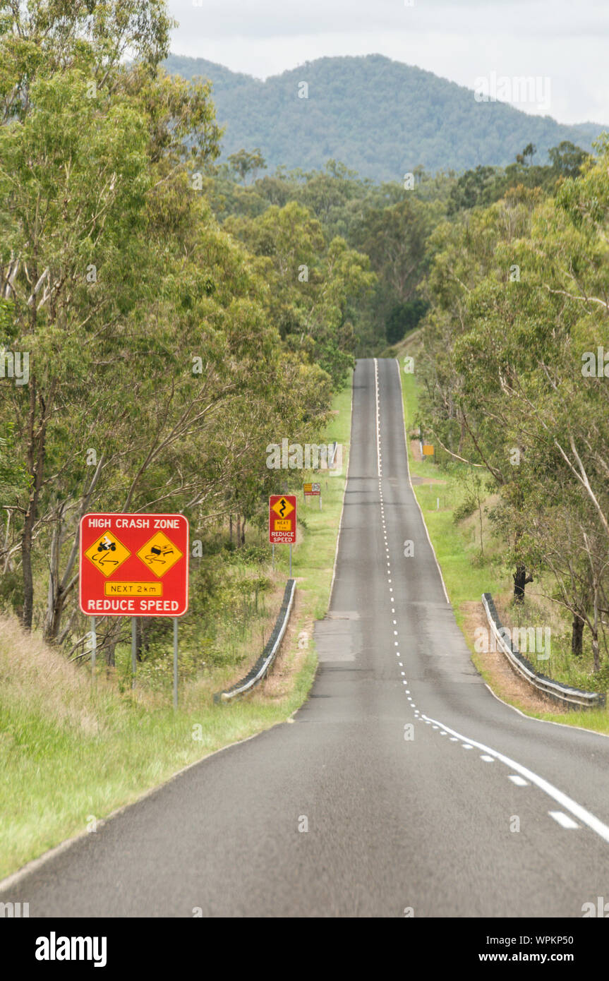 A ‘High Crash Zone’ and ‘Reduced Speed’ road warning sign on the Wivenhoe Somerset road in the Somerset Valley of South east Queensland in Australia Stock Photo