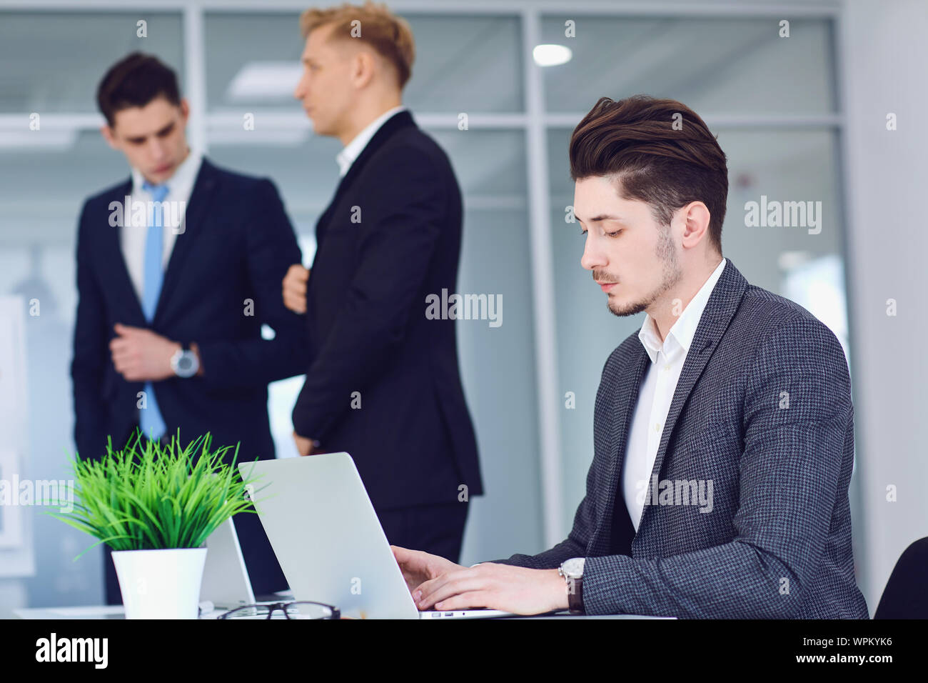 Serious young business people working at a table in an office. Stock Photo