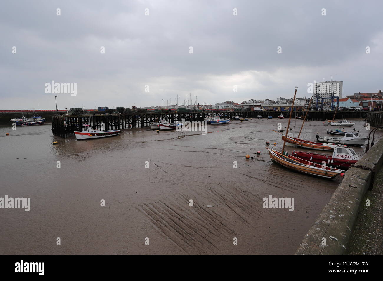 Bridlington harbour at low tide. Bridlington is a tidal harbour which leaves boats stranded when the tide goes out. Stock Photo