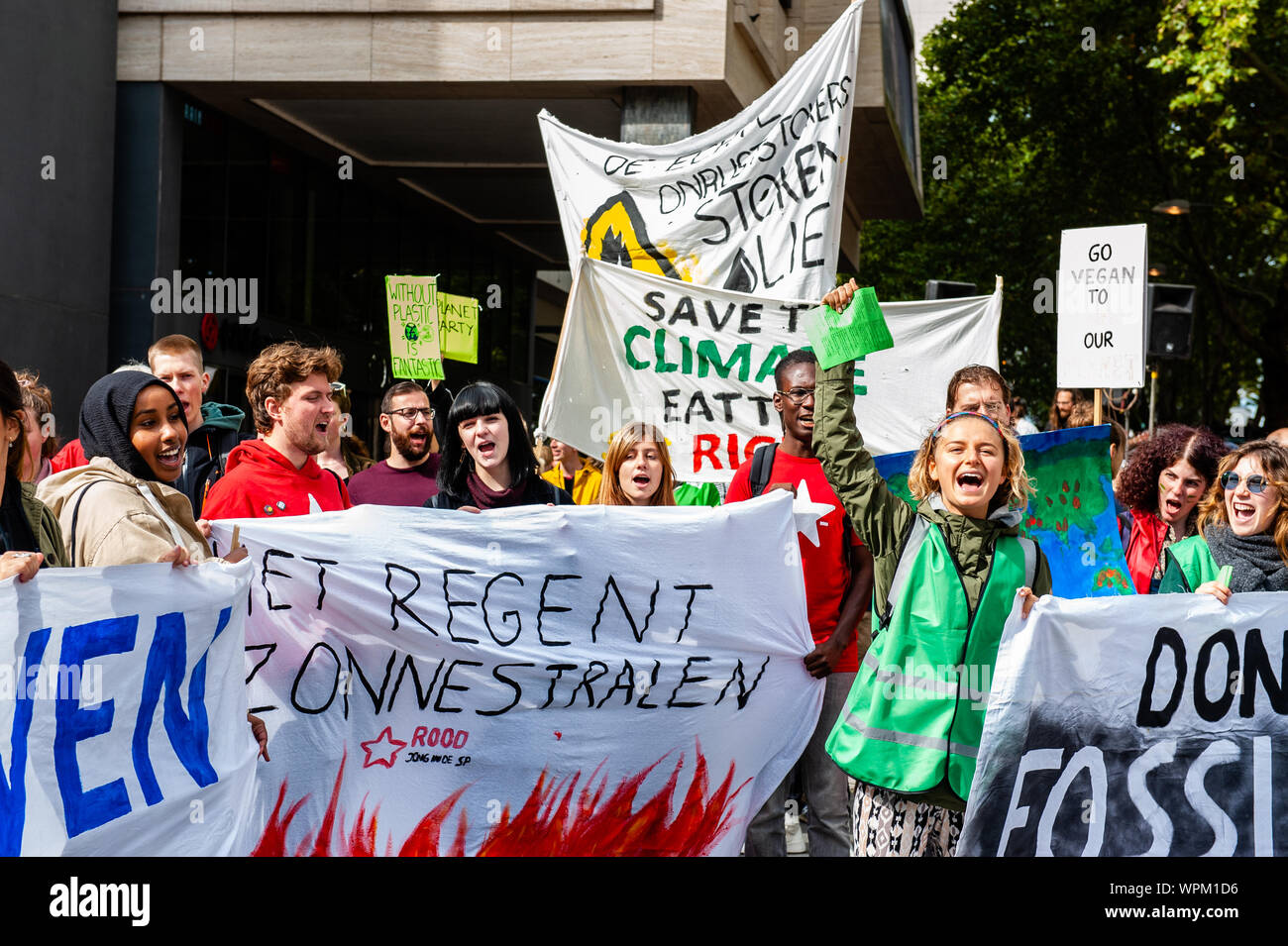 Protesters hold banners and placards while shouting slogans during the demonstration.During the famous world harbour days of Rotterdam, a Climate demonstration was organized by several organizations to demand that the harbour takes its responsibility for the climate crisis. According to the organizations involved in the march, the harbour of Rotterdam is responsible for 1/5th of the total CO2 emissions in the Netherlands. There was a strong police presence where the demonstration was passing by close to the Harbour Festival. Stock Photo