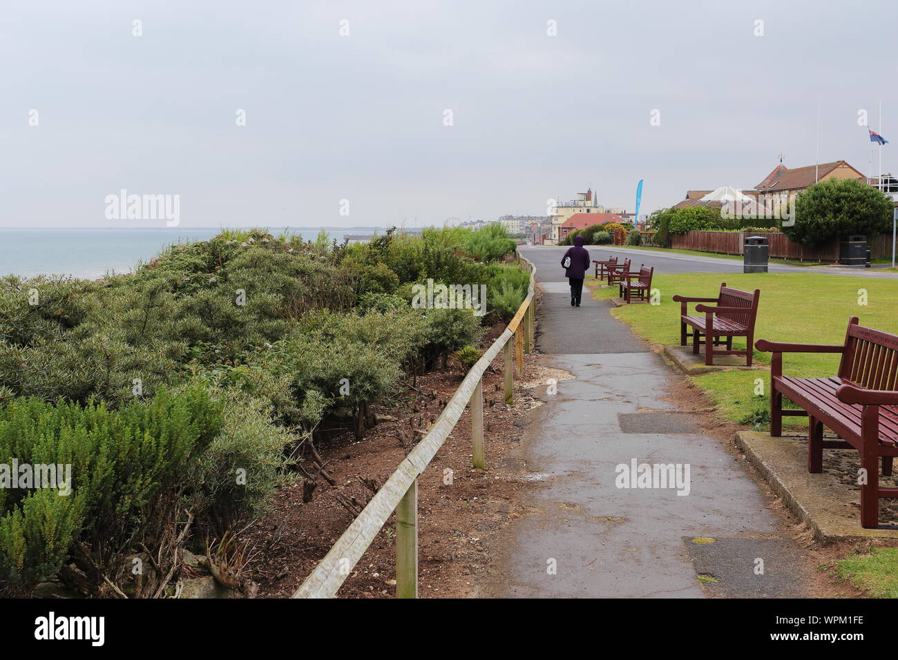 View southwards towards Bridlington harbour take from the northern resting area.  My wife is visible on the path. Stock Photo