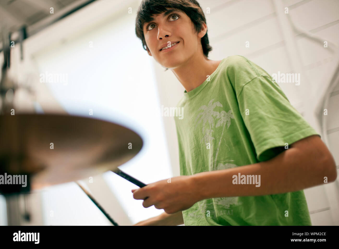 Teenage boy playing the drums. Stock Photo