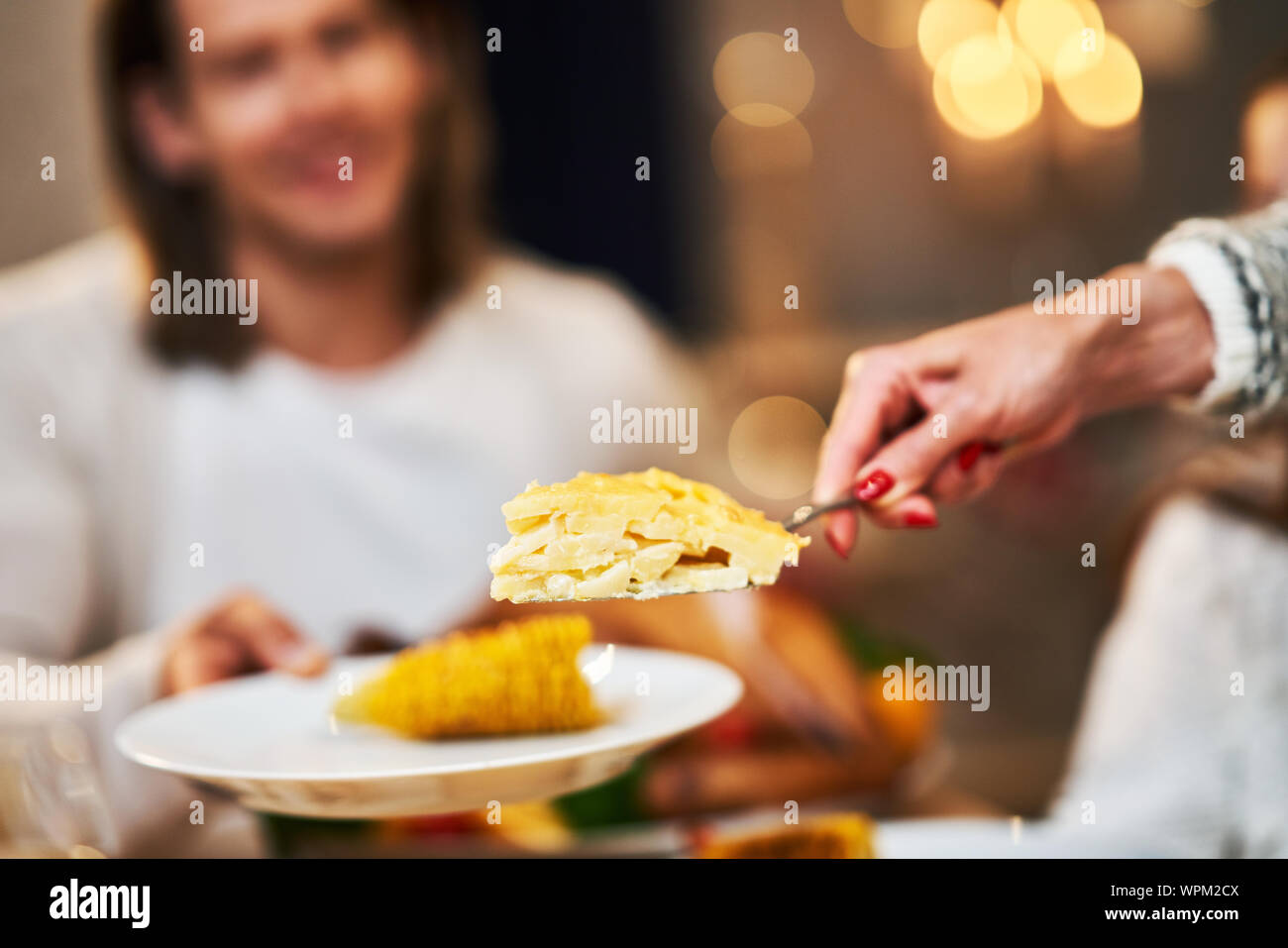 Family celebrating Thanksgiving. Focus on table and dishes Stock Photo