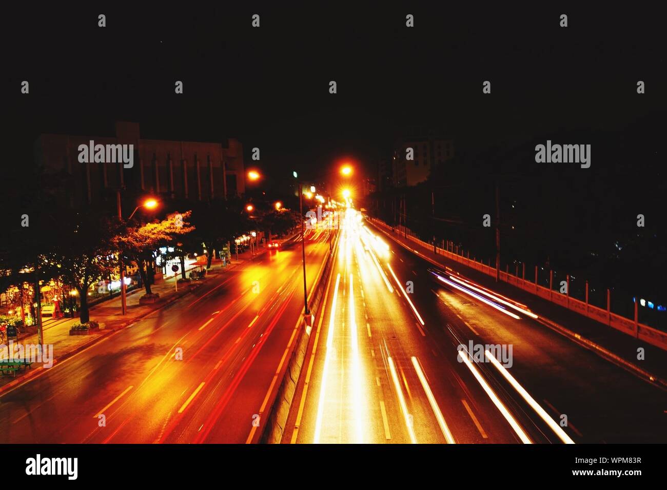 Night Traffic Along Urban Road Stock Photo