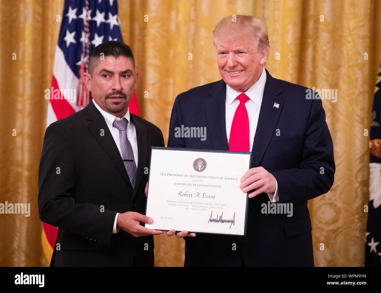 Washington, United States. 09th Sep, 2019. President Donald Trump awards a Heroic Commendations to Robert Evans for his heroic actions during a mass shooting, during a ceremony in the East Room at the White House in Washington, DC on Monday, September 9, 2019. Trump recognized the six Dayton officers who stoped a mass shooting on August 4th and honored 5 civilians who helped during a mass shooting at a Walmart in El Paso a day before. Photo by Kevin Dietsch/UPI Credit: UPI/Alamy Live News Stock Photo