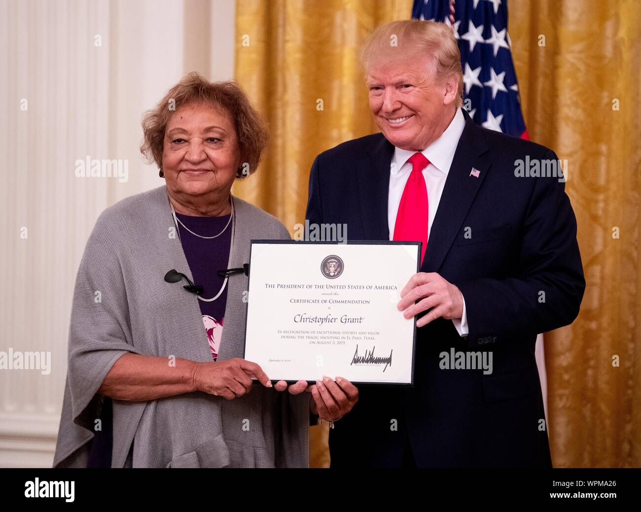 Washington, United States. 09th Sep, 2019. President Donald Trump awards a Heroic Commendations to Christoper Grant for his heroic actions during a mass shooting, as his mother Mimi receives the commendation, during a ceremony in the East Room at the White House in Washington, DC on Monday, September 9, 2019. Trump recognized the six Dayton officers who stoped a mass shooting on August 4th and honored 5 civilians who helped during a mass shooting at a Walmart in El Paso a day before. Photo by Kevin Dietsch/UPI Credit: UPI/Alamy Live News Stock Photo
