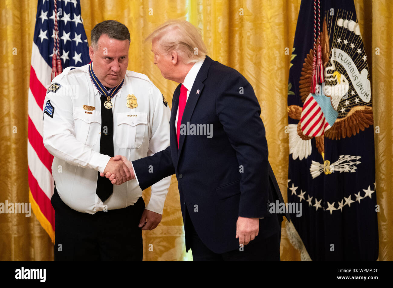 Washington, United States. 09th Sep, 2019. President Donald Trump awards Dayton Police Sgt. William C. Knight the Public Safety Officer Medal of Valor, during a ceremony in the East Room at the White House in Washington, DC on Monday, September 9, 2019. Trump recognized the six Dayton officers who stoped a mass shooting on August 4th and honored 5 civilians who helped during a mass shooting at a Walmart in El Paso a day before. Photo by Kevin Dietsch/UPI Credit: UPI/Alamy Live News Stock Photo