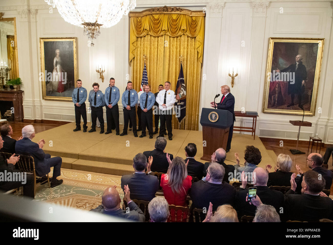 Washington, United States. 09th Sep, 2019. President Donald Trump stands with the recipients of the Public Safety Officer Medal of Valor and recipients of Heroic Commendations, during a ceremony in the East Room at the White House in Washington, DC on Monday, September 9, 2019. Trump recognized the six Dayton police officers who stoped a mass shooting on August 4th and honored 5 civilians who helped during a mass shooting at a Walmart in El Paso the day before. Photo by Kevin Dietsch/UPI Credit: UPI/Alamy Live News Stock Photo