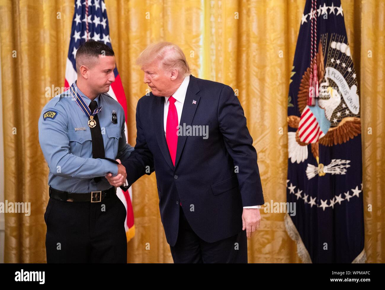 Washington, United States. 09th Sep, 2019. President Donald Trump awards Dayton Police Officer Jeremy Campbell the Public Safety Officer Medal of Valor, during a ceremony in the East Room at the White House in Washington, DC on Monday, September 9, 2019. Trump recognized the six Dayton officers who stoped a mass shooting on August 4th and honored 5 civilians who helped during a mass shooting at a Walmart in El Paso a day before. Photo by Kevin Dietsch/UPI Credit: UPI/Alamy Live News Stock Photo