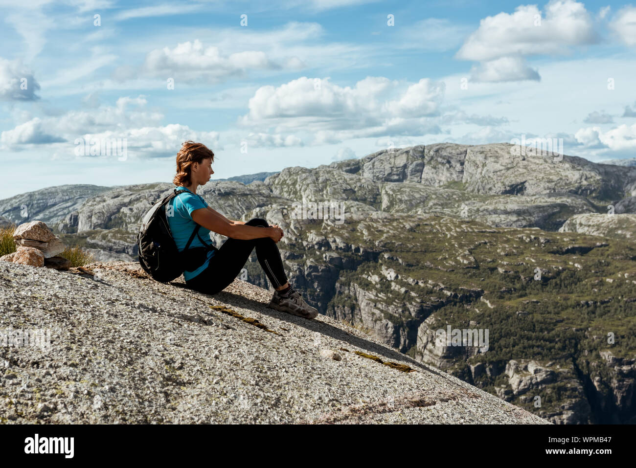 Beautiful woman sitting on rock hi-res stock photography and images - Alamy