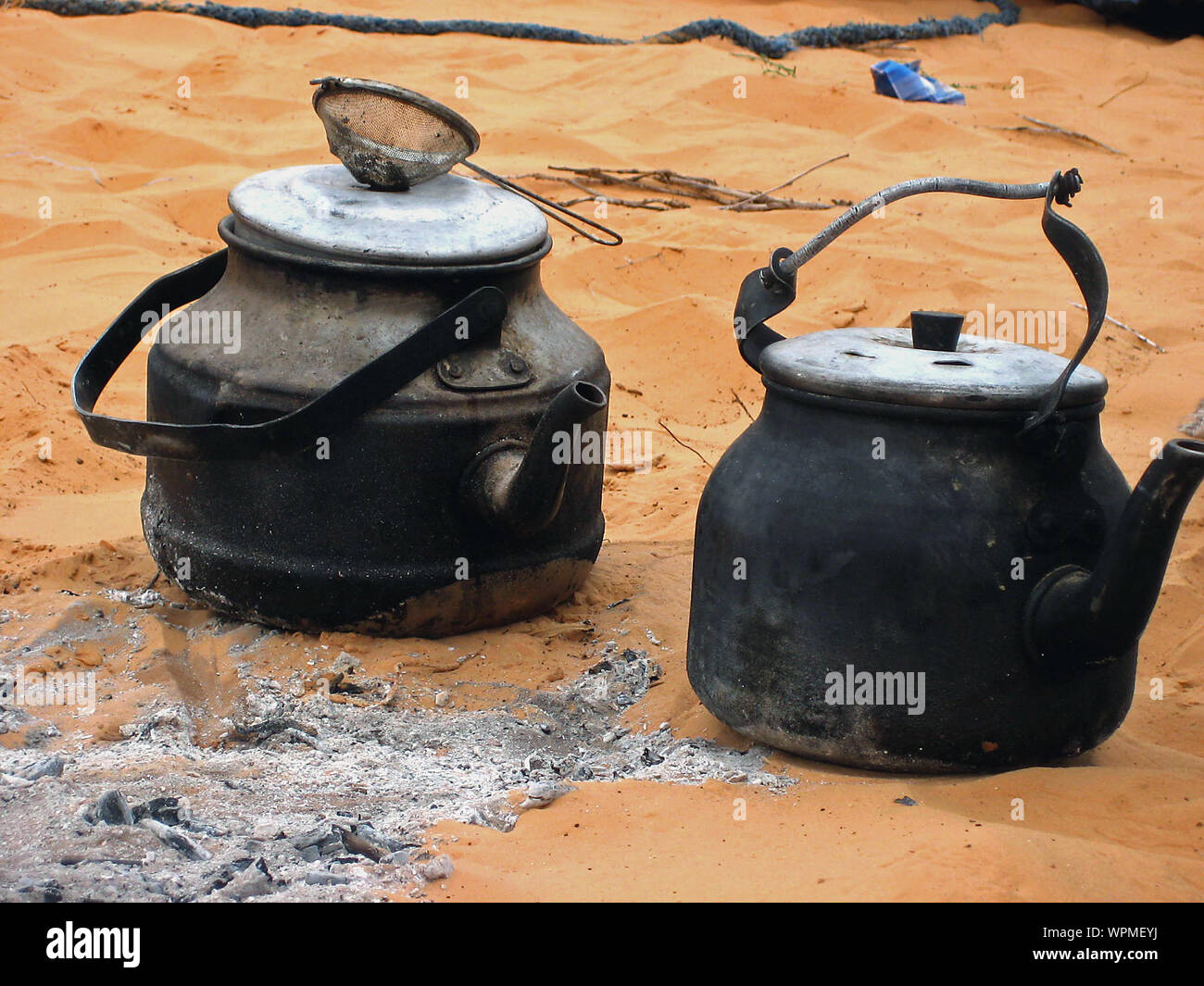 High Angle View Of Burnt Kettles On Sand In Desert Stock Photo - Alamy