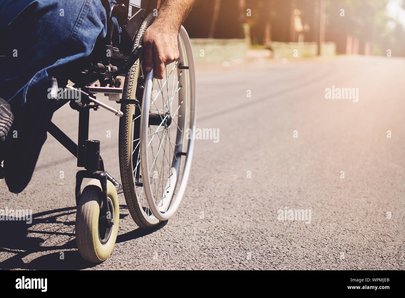 young disabled man in wheelchair walking park Stock Photo Alamy