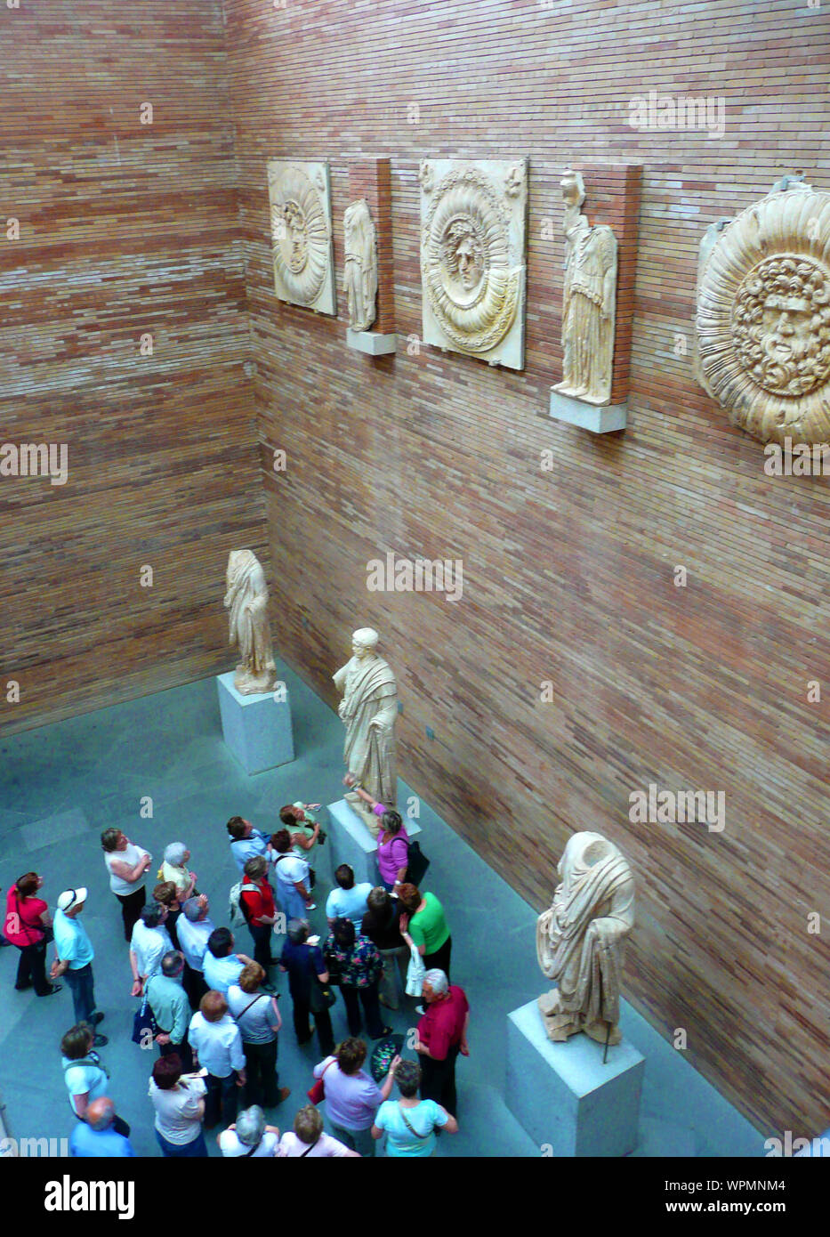 National Museum of Roman Art, Merida, Spain (2009 photograph). A group of visitors study a sculpture Stock Photo