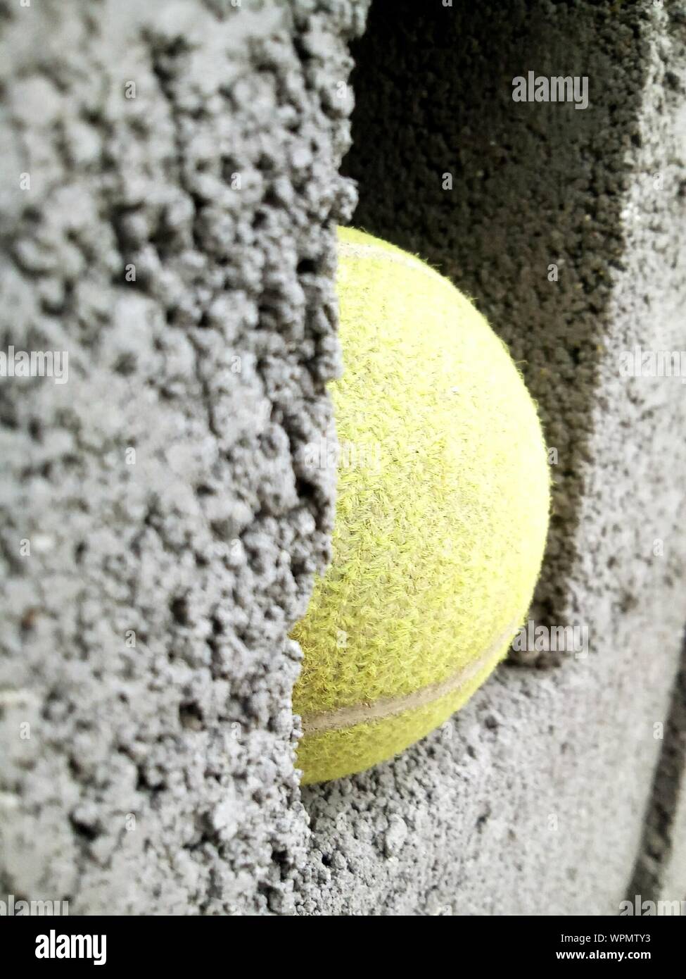 Close-up Of Tennis Ball On Wall Stock Photo