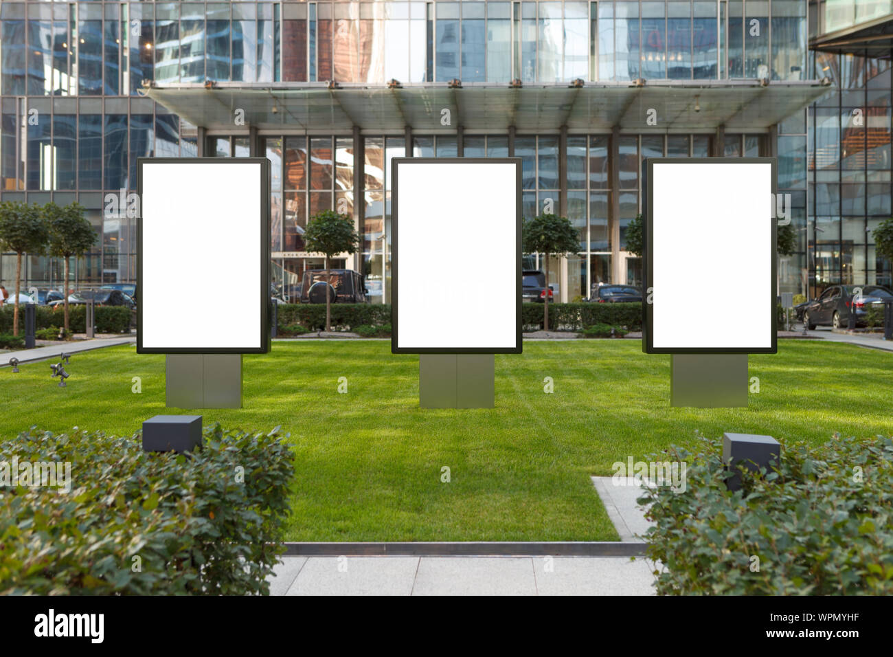 Three blank street billboard poster stands mock up on the lawn in city ...