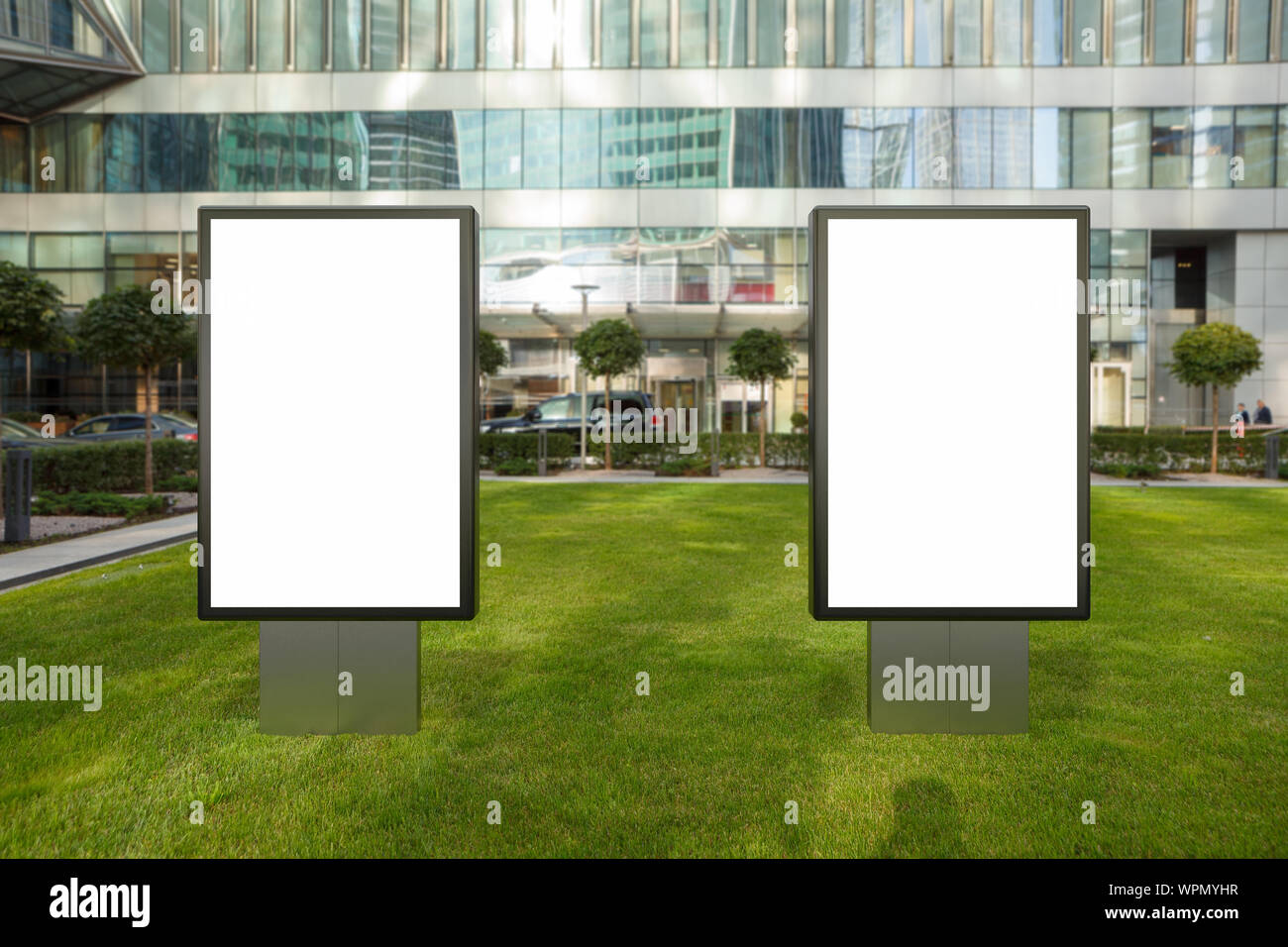 Two blank street billboard poster stands mock up on the lawn in city ...