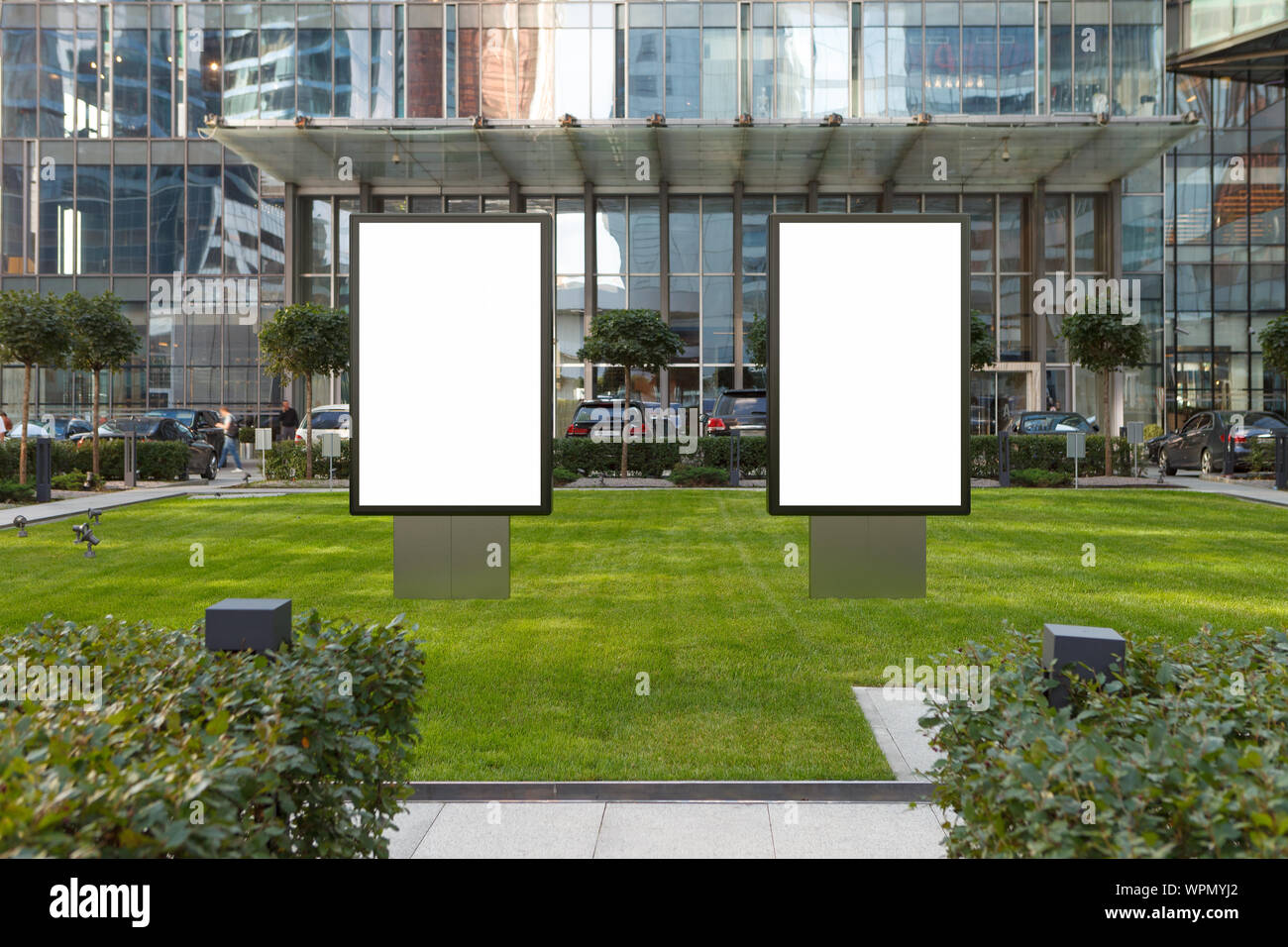 Two blank street billboard poster stands mock up on the lawn in city ...