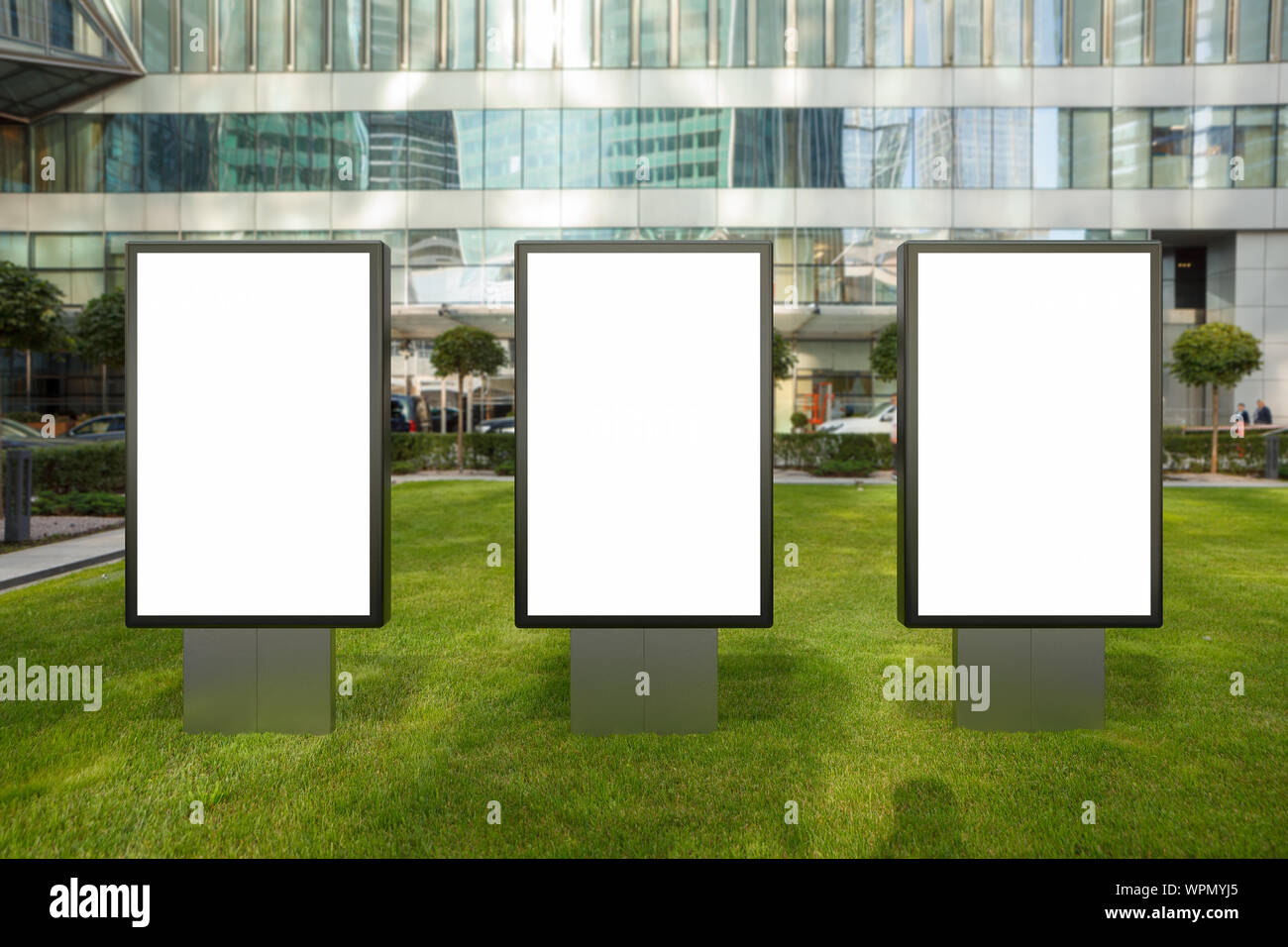 Three blank street billboard poster stands mock up on the lawn in city ...