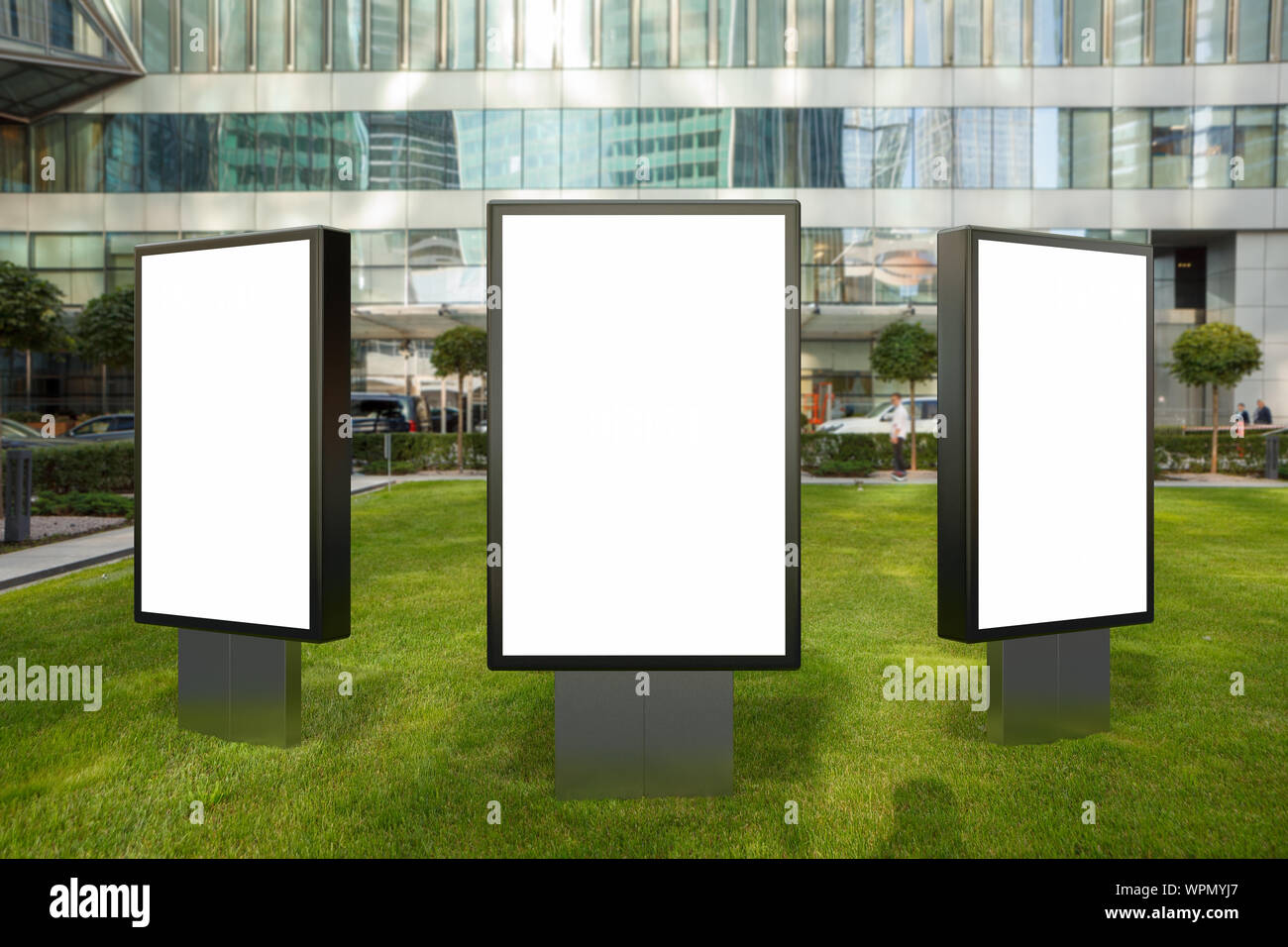 Three blank street billboard poster stands mock up on the lawn in city ...
