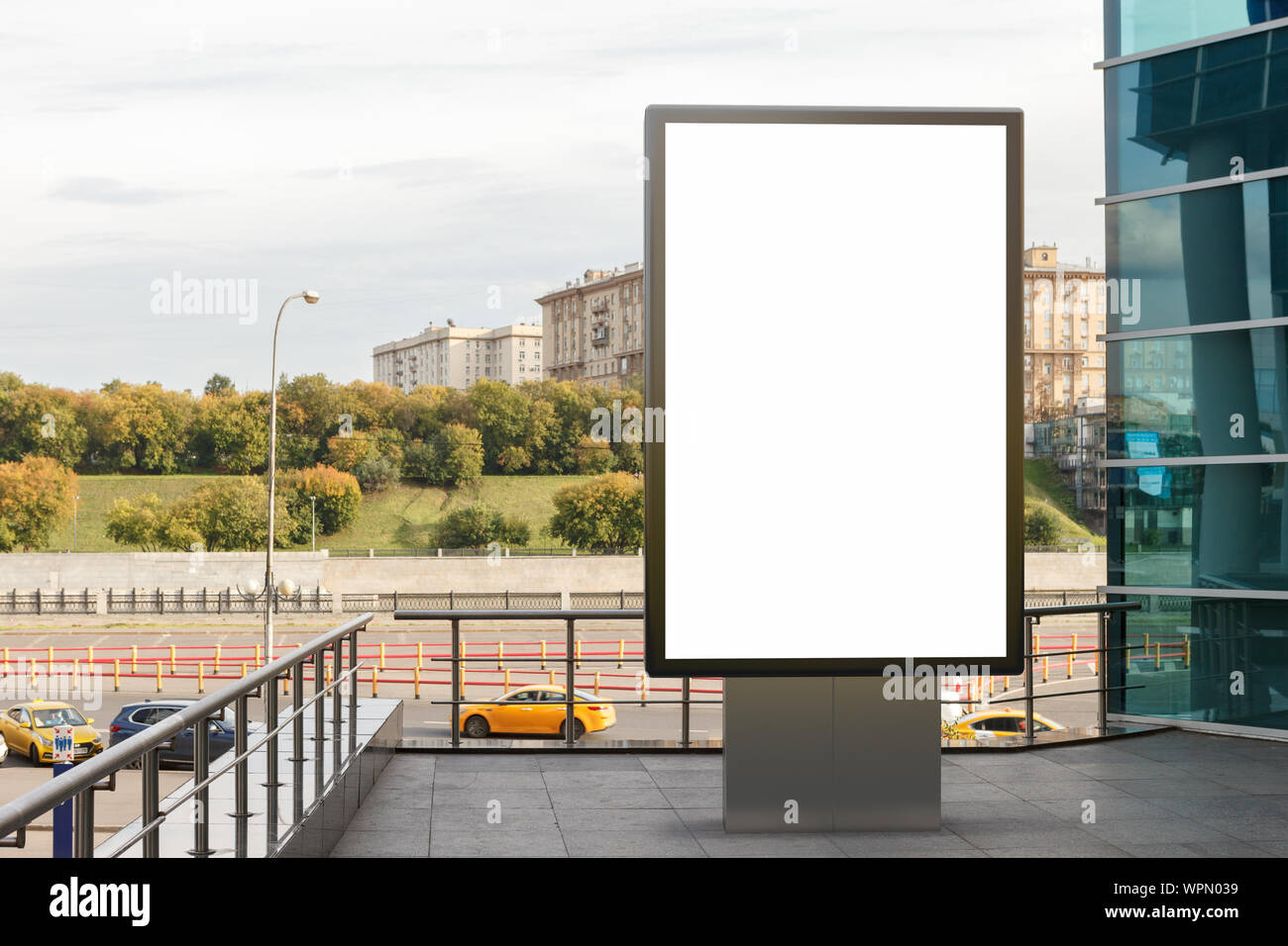 Blank street billboard poster stand mock up in downtown with city ...