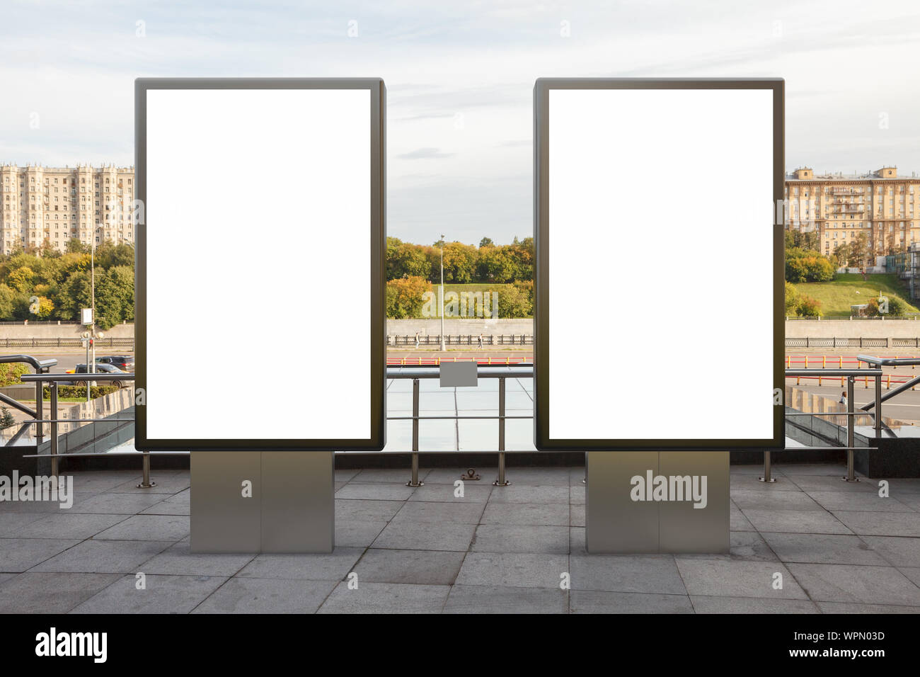 Two blank street billboard poster stands mock up in downtown with city ...