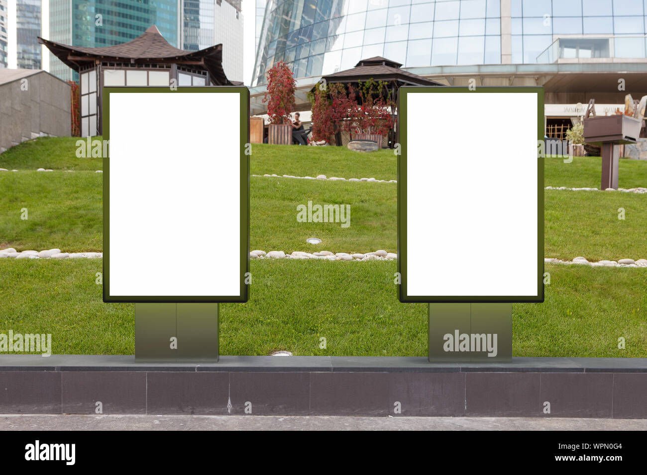 Two blank street billboard poster stands mock up on the lawn in ...