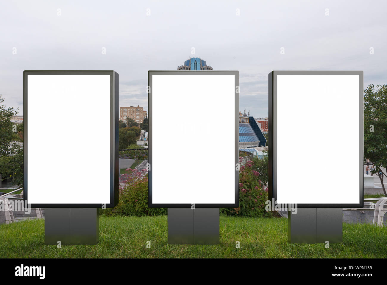 Three blank street billboard poster stands mock up in on the lawn in ...